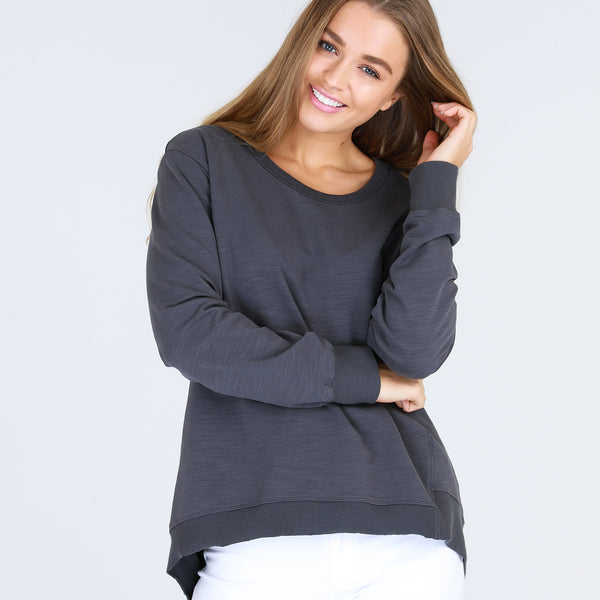 The Newhaven Sweater is a relaxed, mid-weight sweater that features an asymmetrical hemline that dips at the back on one side, as a stylish point of difference.  This will become your new favourite sweat to wear on a casual weekend, to the gym and when travelling.  Designed for an oversized look.  FEATURES Round neckline Hi-Lo hemline – shorter at the front, dipping longer to one side at the back Relaxed fit Ribbed edging FABRIC 100% Cotton Warm machine wash