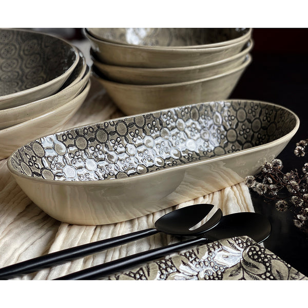 Black Lace Bread Basket. Every single piece of Wonki Ware is made by hand. From a delicate salt dish to a generous platter, each piece goes through the same creative process, which sees the clay moulded, shaped, smoothed and painted during 15 different stages on the journey from clay to table.