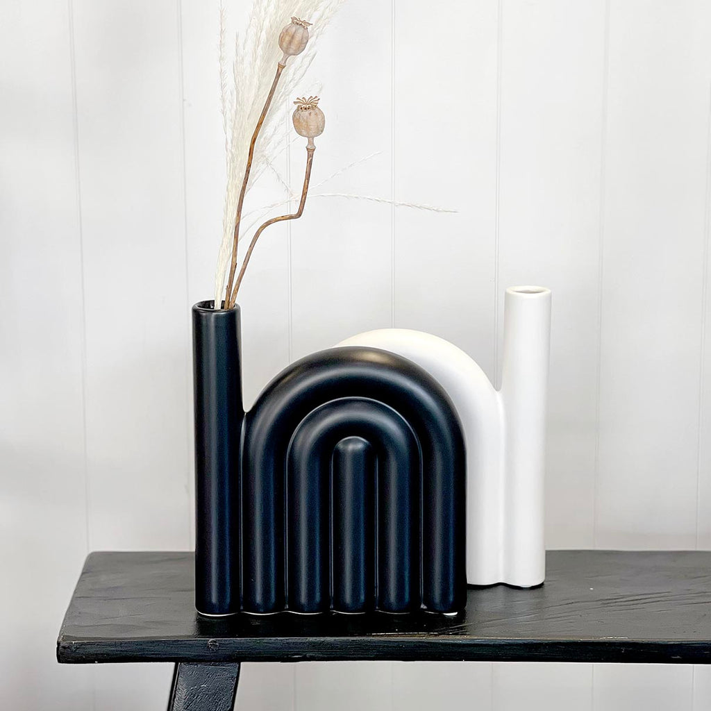 The Harold ceramic vase is available in either black or white. With it's natural curves and elegant matte finish this vase looks great on it's own or pair it with the Henrik vase.  Size: W20.5 x D3.5 x H23.2 cm