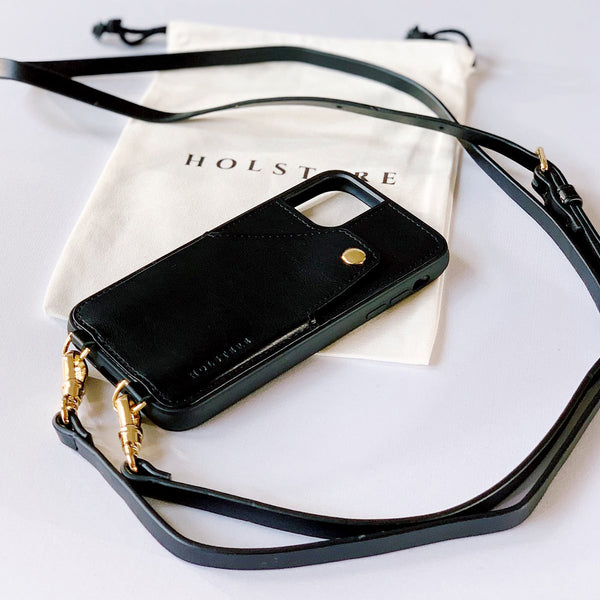 Holstere London Black Leather iPhone case with strap. Free your hands with this luxury iPhone case crossbody in black high-quality smooth leather. Elegant, timeless, and classic with straight lines and detailed stitching for a sleek, polished look. Durable construction offers a modern, sophisticated, chic look. Leather finish feels luxurious to the touch. Case fully wraps around iPhone for ultimate protection.