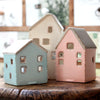 This house-shaped tealight holder will look beautiful displayed in a lounge, hallway or anywhere you need to add style and ambience.  Featuring little cut out windows which allow the candle glow to shine through.  Wonderful on its own or pair with the other colours/sizes. A great gift idea.  Blue/brown house size: 73 x 71 x 90mm  Pink/brown house size: 71 x 71 x 113mm  Brown house size: 74mm x 74mm x 145mm   Made of 100% Dolomite