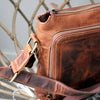 Genuine Smooth Leather Cross Body Satchel  Leather/Woven Canvas adjustable strap   Multi compartment with three separate zip closings   Multiple internal zip pockets and compartments   Suitable for small laptop (11inch), ipad or similar Rich Mahogany Brown with antique gold fittings  Size: 340 W x 255 H x 50 D mm Strap Length (Total) 1200 mm