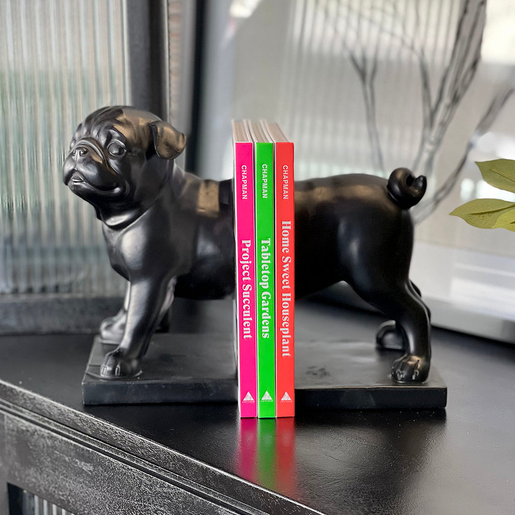 Pug Bookends. Everybody needs a pug guarding their books! Perfect for display on your shelf, mantle, desk, table, or counter top.  Details: • Made of polyresin and stone powder • Matt black • Size H219 x W123 x D200mm