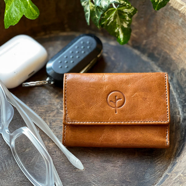 Second Nature leather wallet. The perfect mini wallet for him or her.  Details: • Soft Genuine Leather Coin Purse with Wallet • Flap Over with Dome Closure • One Note Compartment, Two Card Holder Slots • Flap Over Dome Closure Coin Purse • Complimentary Lining • W:95mm H:65mm